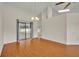 Bright living room with wood-look tile flooring and sliding glass doors leading to the lanai, creating an open and airy space at 2237 Clearwater Dr, Deltona, FL 32738