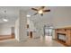 Open living area with tile flooring and a brick fireplace, seamlessly connecting to the kitchen, perfect for entertaining at 2237 Clearwater Dr, Deltona, FL 32738