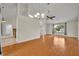 Spacious living room with wood-look tile flooring and a large window, offering a comfortable and inviting atmosphere at 2237 Clearwater Dr, Deltona, FL 32738