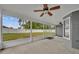 Screened porch features a ceiling fan and views of the well-maintained, fenced backyard at 2237 Clearwater Dr, Deltona, FL 32738