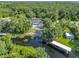 An aerial view of a lovely home featuring a private pool and waterfront views with a covered boat dock at 28432 Tammi Dr, Tavares, FL 32778