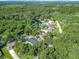 Expansive aerial view showcasing the property's tranquil and private setting surrounded by lush greenery at 28432 Tammi Dr, Tavares, FL 32778