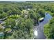 A stunning aerial view of a home with lush greenery, a private dock, and waterfront access at 28432 Tammi Dr, Tavares, FL 32778