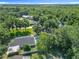 Aerial view of the property with a swimming pool, lush greenery, and a winding waterway, showcasing its serene setting at 28432 Tammi Dr, Tavares, FL 32778