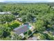 Aerial view showcasing a home with a private pool surrounded by lush greenery and mature trees at 28432 Tammi Dr, Tavares, FL 32778