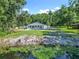 Expansive backyard with pool and waterway views, offering a perfect blend of recreation and natural beauty for outdoor living at 28432 Tammi Dr, Tavares, FL 32778