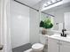 Bathroom featuring a white tiled shower and updated vanity at 28432 Tammi Dr, Tavares, FL 32778