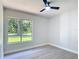 View of bright bedroom with large window showcasing the exterior at 28432 Tammi Dr, Tavares, FL 32778