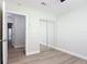 Bright bedroom with mirrored closet doors and modern gray vinyl flooring at 28432 Tammi Dr, Tavares, FL 32778