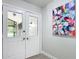 Inviting entryway featuring double doors, modern art, and neutral tones creating a welcoming ambiance at 28432 Tammi Dr, Tavares, FL 32778