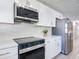 Close-up of a well-appointed kitchen featuring stainless steel appliances and sleek countertops at 28432 Tammi Dr, Tavares, FL 32778