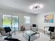 Modern living room featuring stylish seating, a game table, and a view of the outdoor pool at 28432 Tammi Dr, Tavares, FL 32778