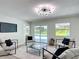 Bright and airy living room with contemporary furnishings, pool view, and decorative lighting at 28432 Tammi Dr, Tavares, FL 32778