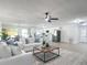 Spacious living area that flows into an open kitchen, dining room, and access to outside at 28432 Tammi Dr, Tavares, FL 32778