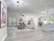 Open concept living area with modern decor, light gray flooring, and seamless flow to kitchen and dining at 28432 Tammi Dr, Tavares, FL 32778