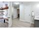 Functional mudroom with bench, shelving, hooks and access to the bathroom at 28432 Tammi Dr, Tavares, FL 32778