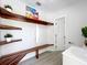 Functional mudroom with bench seating, open shelving and access to bathroom at 28432 Tammi Dr, Tavares, FL 32778