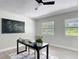 Home office with natural light, neutral color palette, desk, and view to the outside at 28432 Tammi Dr, Tavares, FL 32778