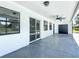 Covered patio features modern fixtures and dark framed windows with a dark concrete floor, great for outdoor entertaining at 28432 Tammi Dr, Tavares, FL 32778