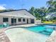 Rear exterior view of the home showcasing the pool, spa, and covered lanai, perfect for relaxation and outdoor enjoyment at 28432 Tammi Dr, Tavares, FL 32778