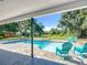 View of the pool, spa, and natural surroundings from the covered lanai, offering a private and tranquil outdoor retreat at 28432 Tammi Dr, Tavares, FL 32778