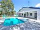 Backyard oasis with a sparkling pool, inviting spa, and comfortable lounge chairs for ultimate relaxation and enjoyment at 28432 Tammi Dr, Tavares, FL 32778
