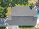 Aerial shot of a new roof with green backyard, sparkling pool, and deck at 28432 Tammi Dr, Tavares, FL 32778