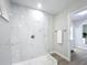 Stunning bathroom shower with modern fixtures, marble tiling, and convenient towel bar at 28432 Tammi Dr, Tavares, FL 32778