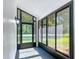 Enclosed sunroom featuring bright windows, natural light, and stylish blue painted floors at 28432 Tammi Dr, Tavares, FL 32778