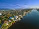 Stunning aerial view of waterfront homes with private docks on a tranquil river leading to the ocean at 3110 John Anderson Dr, Ormond Beach, FL 32176
