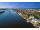 Stunning aerial view of waterfront homes along the river and coast under a blue sky at 3110 John Anderson Dr, Ormond Beach, FL 32176