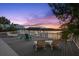 Inviting backyard deck with lounge seating overlooking the serene waterfront at sunset at 3110 John Anderson Dr, Ormond Beach, FL 32176