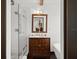 Bathroom with a vanity cabinet, white tile shower and freestanding soaking tub at 3110 John Anderson Dr, Ormond Beach, FL 32176