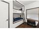 Bright room showing built-in bunk beds with wooden ladder, individual reading lights and bedside decor at 3110 John Anderson Dr, Ormond Beach, FL 32176