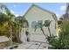 Charming home with a two-car garage, lush landscaping, and a welcoming entrance at 3110 John Anderson Dr, Ormond Beach, FL 32176