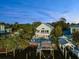 Beautiful home with a dock, boat lift, and pool overlooking the water with lush green landscaping at 3110 John Anderson Dr, Ormond Beach, FL 32176