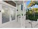 Close up of a inviting front entrance with glass doors and lush landscaping at 3110 John Anderson Dr, Ormond Beach, FL 32176