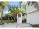 Inviting front entrance with white stairs, lush landscaping, and a two-car garage at 3110 John Anderson Dr, Ormond Beach, FL 32176