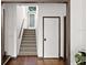 Bright hallway with hardwood floors, staircase, and white doors with modern trim at 3110 John Anderson Dr, Ormond Beach, FL 32176