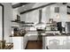 Kitchen with stainless steel appliances, open shelving, dark countertops, and white cabinets at 3110 John Anderson Dr, Ormond Beach, FL 32176