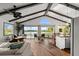 Spacious living room with exposed beams, wood floors, waterfront view and modern furnishings at 3110 John Anderson Dr, Ormond Beach, FL 32176