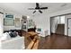 Inviting living room featuring hardwood floors, a ceiling fan, and stylish, comfortable white seating at 3110 John Anderson Dr, Ormond Beach, FL 32176
