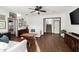 Inviting living room featuring hardwood floors, a ceiling fan, and stylish, comfortable white seating at 3110 John Anderson Dr, Ormond Beach, FL 32176