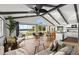 Spacious living room with exposed beams, wood floors, waterfront view and modern furnishings at 3110 John Anderson Dr, Ormond Beach, FL 32176