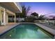 Private outdoor pool area with deck, lounge chairs, and lush landscaping for relaxation at 3110 John Anderson Dr, Ormond Beach, FL 32176