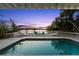 Relaxing pool area with comfortable lounge chairs and a picturesque waterfront view at sunset at 3110 John Anderson Dr, Ormond Beach, FL 32176