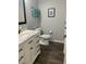 Bright bathroom featuring a white vanity with marble countertop and modern fixtures at 3339 Croton Ave, Deltona, FL 32738