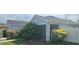 Home's exterior showcases lush landscaping and screened porch for outdoor enjoyment at 3339 Croton Ave, Deltona, FL 32738
