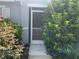 Charming entryway with a screen door and lush, colorful landscaping at 3339 Croton Ave, Deltona, FL 32738