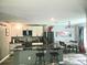 Eat-in kitchen boasts black appliances, island with seating, and stylish chandelier at 3339 Croton Ave, Deltona, FL 32738